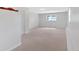 Spacious finished basement with neutral carpet, white walls, and a window for natural light at 4807 Willowwood Ne Dr, Kennesaw, GA 30144