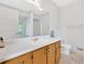 Bright bathroom with vanity, single sink, large mirror and neutral walls at 4807 Willowwood Ne Dr, Kennesaw, GA 30144
