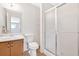 Bathroom features a vanity, toilet, shelving and shower with glass doors at 4807 Willowwood Ne Dr, Kennesaw, GA 30144