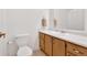 Cozy bathroom with single sink vanity, neutral paint and updated toilet at 4807 Willowwood Ne Dr, Kennesaw, GA 30144