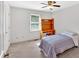 Bright bedroom with large window, ceiling fan, closet, and simple decor at 4807 Willowwood Ne Dr, Kennesaw, GA 30144