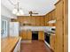 Functional kitchen with wooden cabinets, white appliances, and a dining area at 4807 Willowwood Ne Dr, Kennesaw, GA 30144