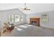 Bright living room with a fireplace, carpeted floor, vaulted ceiling, and large windows at 4807 Willowwood Ne Dr, Kennesaw, GA 30144