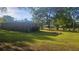 Spacious backyard featuring beautiful landscaping and mature trees at 112 Hilltop Dr, Newborn, GA 30056
