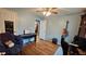 Relaxing bedroom with hardwood floors, blue walls, a comfortable chair, and musical instruments at 112 Hilltop Dr, Newborn, GA 30056