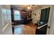Bright bedroom featuring hardwood floors, a ceiling fan, built-in shelving, and ample natural light at 112 Hilltop Dr, Newborn, GA 30056