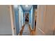 Hallway with blue walls, wood floors, and a rug leading to the dining room at 112 Hilltop Dr, Newborn, GA 30056