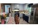 Charming kitchen with grey cabinetry, stainless steel appliances, and a dining area at 112 Hilltop Dr, Newborn, GA 30056