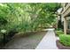 A view of the green and leafy backyard showing the walking path and iron fence at 116 Festoon Ct, Smyrna, GA 30080