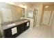 Bright bathroom features double sinks with granite countertops and a glass-enclosed shower at 116 Festoon Ct, Smyrna, GA 30080