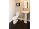 Powder room features a pedestal sink and dark hardwood floors at 116 Festoon Ct, Smyrna, GA 30080