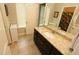 Granite vanity in a bathroom featuring a white sink, mirror, tiled floors, and a shower with a decorative curtain at 116 Festoon Ct, Smyrna, GA 30080