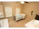 Well-lit bedroom with a dresser, desk, natural light, and neutral walls creating a serene atmosphere at 116 Festoon Ct, Smyrna, GA 30080