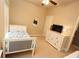 Bright bedroom featuring neutral walls, a ceiling fan, white furniture, and natural light from the window at 116 Festoon Ct, Smyrna, GA 30080