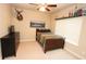 Cozy bedroom featuring a mounted deer head, ceiling fan, neutral walls, and a wooden bed frame at 116 Festoon Ct, Smyrna, GA 30080