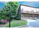 Exterior of townhouse featuring a garage and second story deck, surrounded by lush greenery at 116 Festoon Ct, Smyrna, GA 30080