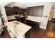 Bright kitchen featuring dark cabinetry, stainless steel appliances, light granite countertops and island with seating at 116 Festoon Ct, Smyrna, GA 30080
