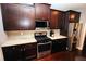 Beautiful kitchen featuring dark cabinetry, stainless steel appliances, and light granite countertops at 116 Festoon Ct, Smyrna, GA 30080