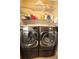 Laundry room with side-by-side washer and dryer and shelving at 116 Festoon Ct, Smyrna, GA 30080