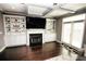 Cozy living room with built-in shelving, fireplace, and stylish dark-stained hardwood floors at 116 Festoon Ct, Smyrna, GA 30080