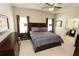 Spacious main bedroom featuring a tray ceiling, plush carpet, and access to the bathroom at 116 Festoon Ct, Smyrna, GA 30080