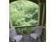 Relax on the outdoor patio with serene views of the surrounding lush greenery at 116 Festoon Ct, Smyrna, GA 30080