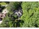 Charming home seen from above is nestled among mature trees with lush green landscape at 181 Sentinel Pl, Marietta, GA 30067