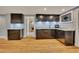 Basement wet bar features stainless steel appliances, custom cabinets and marble countertop at 181 Sentinel Pl, Marietta, GA 30067