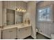 Well-lit bathroom with a decorative window, vanity, and overhead lighting at 181 Sentinel Pl, Marietta, GA 30067