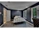 A relaxing bedroom features dark blue walls and a wrought iron bedframe at 181 Sentinel Pl, Marietta, GA 30067