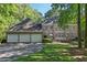 Beautiful brick home with a three-car garage and a well-manicured lawn and landscape at 181 Sentinel Pl, Marietta, GA 30067