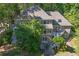 Home featuring multiple decks and brick exterior with mature trees, nestled in a lush setting at 181 Sentinel Pl, Marietta, GA 30067