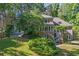 Brick home with multi-level decks and patios surrounded by mature trees and green landscaping at 181 Sentinel Pl, Marietta, GA 30067