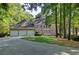 Beautiful brick home with a three-car garage and a well-manicured lawn and landscape at 181 Sentinel Pl, Marietta, GA 30067