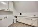 Bright laundry room with ample counter space, cabinets, and tile flooring at 181 Sentinel Pl, Marietta, GA 30067