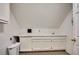 Functional laundry room featuring white cabinets, utility sink, and tile flooring at 181 Sentinel Pl, Marietta, GA 30067