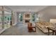Inviting living room with fireplace, large windows, and entry to the sunroom at 181 Sentinel Pl, Marietta, GA 30067