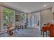 Sunlit living room featuring large windows, a sitting area, and entry to the stairway at 181 Sentinel Pl, Marietta, GA 30067