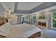 Spacious main bedroom featuring a fireplace, tray ceiling, and large windows at 181 Sentinel Pl, Marietta, GA 30067