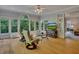 Inviting sunroom featuring hardwood floors, large windows overlooking lush greenery, and comfortable seating at 181 Sentinel Pl, Marietta, GA 30067