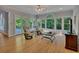 Bright sunroom with hardwood floors, large windows, and cozy seating, creating a tranquil and inviting space at 181 Sentinel Pl, Marietta, GA 30067