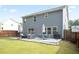 Backyard patio with outdoor seating, lush green lawn, and a well-maintained fence at 2210 Valley Creek Dr, Lithia Springs, GA 30122
