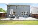 A patio area is furnished with seating and dining, perfect for outdoor living in the spacious backyard at 2210 Valley Creek Dr, Lithia Springs, GA 30122