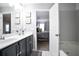 Bathroom featuring double sinks, stylish decor, and an open view to the primary bedroom at 2210 Valley Creek Dr, Lithia Springs, GA 30122