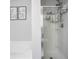 Modern bathroom showcasing a sleek shower with unique glass artwork and a soaking tub at 2210 Valley Creek Dr, Lithia Springs, GA 30122