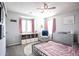 Bright bedroom featuring pink accents, a comfortable chair, and a dresser at 2210 Valley Creek Dr, Lithia Springs, GA 30122