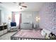 Cozy bedroom with floral wallpaper, plush rug, and a comfortable armchair at 2210 Valley Creek Dr, Lithia Springs, GA 30122
