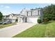 Charming two-story home with a two-car garage, a long driveway, and manicured lawn at 2210 Valley Creek Dr, Lithia Springs, GA 30122