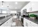 Well-lit kitchen showcases stainless steel appliances, granite countertops, and white cabinets at 2210 Valley Creek Dr, Lithia Springs, GA 30122