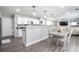 Open-concept kitchen boasts breakfast bar and modern appliances and adjacent living area at 2210 Valley Creek Dr, Lithia Springs, GA 30122